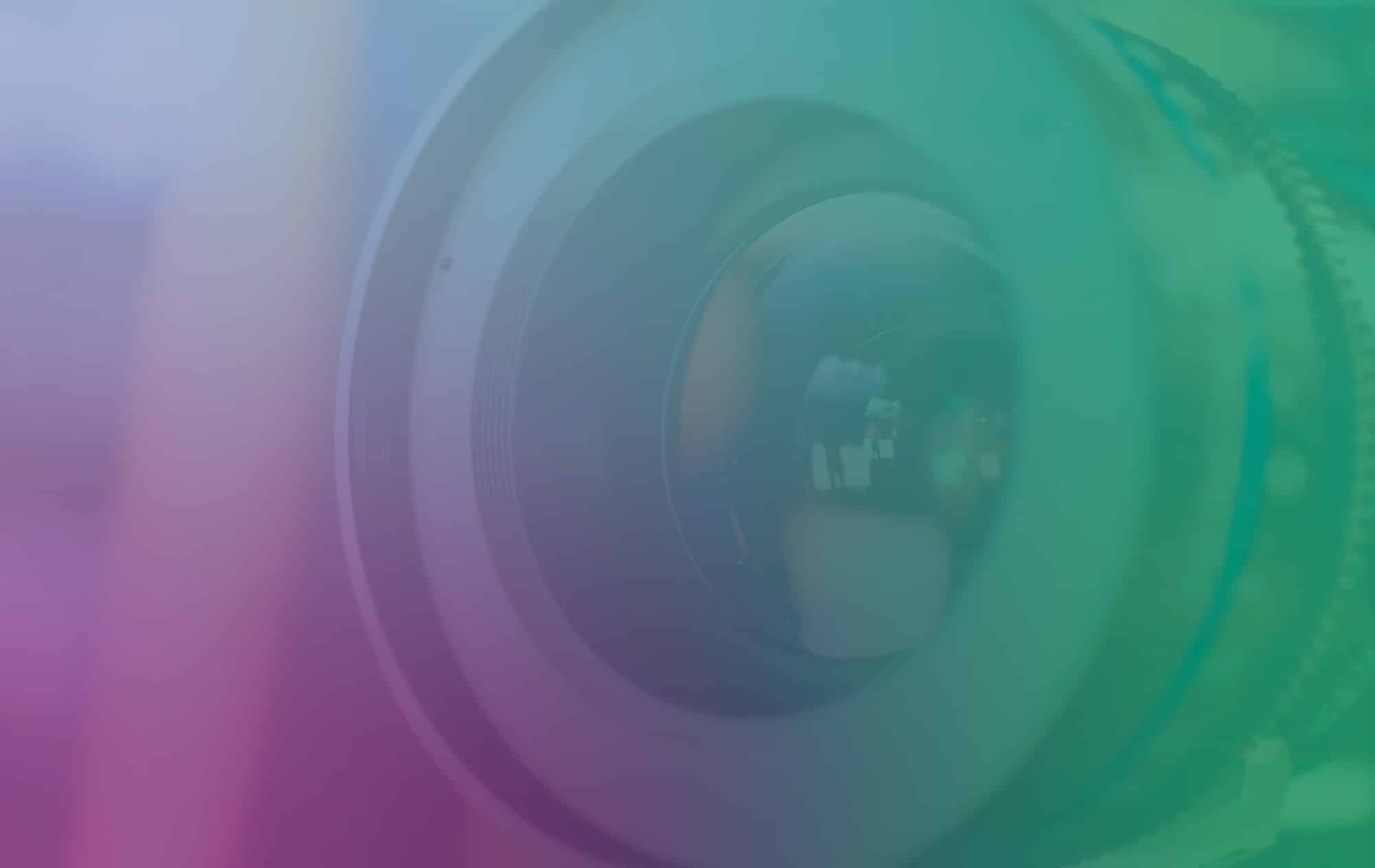 Image of camera lense underneath purple and green gradients
