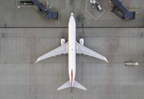 Top down view of a white airplane on the tarmac