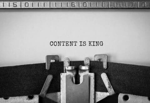 Close up of a typerwriter with the words 'content is king' for content marketing kpis