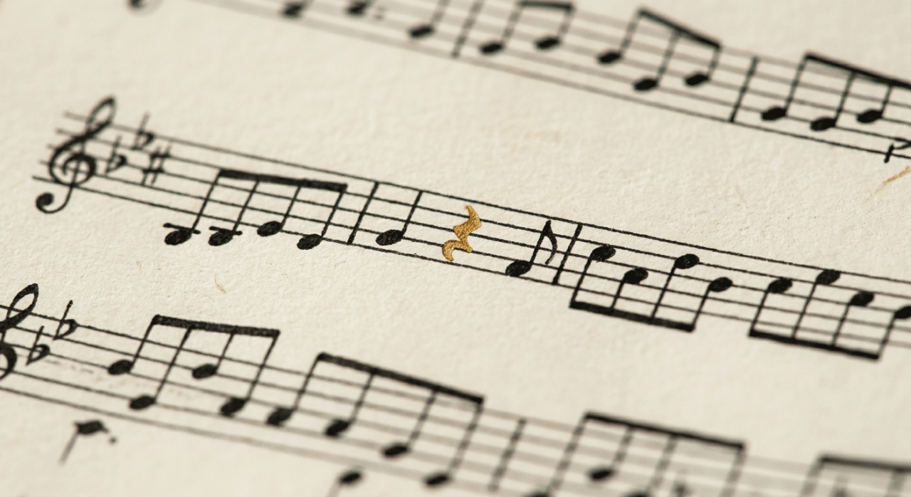 Black and white sheet muuic with one gold note