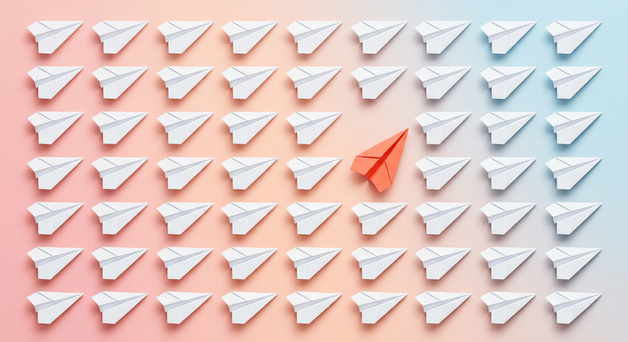 several white paper airlines, one is bright orange